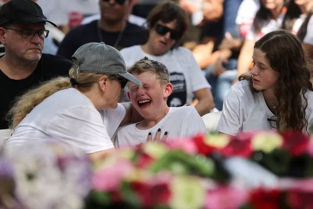 Shahar, 9, the brother of Maayan Idan, 18, who was killed following a deadly infiltration by Hamas gunmen in kibbutz Nahal Oz, and son of Tzahi who was kidnapped to the Gaza Strip, reacts during Maayan's funeral in kibbutz Einat, Israel on October 22, 2023. (Photo by Tomer Appelbaum/Reuters)