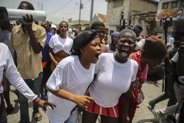 People march to demand justice for slain Haitian President Jovenel Moise in Lower Delmas, a district of Port-au-Prince, Haiti, Monday, July 26, 2021. Moise was assassinated on July 7 at his home. (Photo by Matias Delacroix/AP Photo)