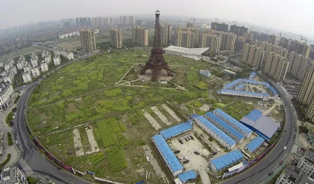 An aerial view shows a replica of the Eiffel Tower (C) and residential buildings at the Tianducheng development in Hangzhou, Zhejiang province April 8, 2015. (Photo by Reuters/Stringer)