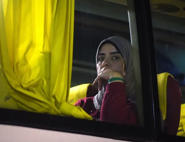 A woman looks out of a bus window as Palestinians with Canadian passports who were evacuated from Gaza react on a bus after through the Rafah border crossing from the Egyptian side in Rafah, amid the ongoing conflict between Israel and Palestinian Islamist group Hamas, in Rafah, Egypt on November 12, 2023. (Photo by Hadeer Mahmoud/Reuters)