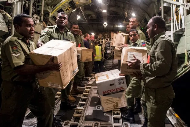 Aid supplies including generators, ration packs and water containers are unloaded by Fijian soldiers from a Royal New Zealand Air Force C-130 Hercules aircraft after Cyclone Winston in Suva, Fiji, in this handout image supplied by the New Zealand Defence Force February 23, 2016. (Photo by Reuters/NZ Defence Force)