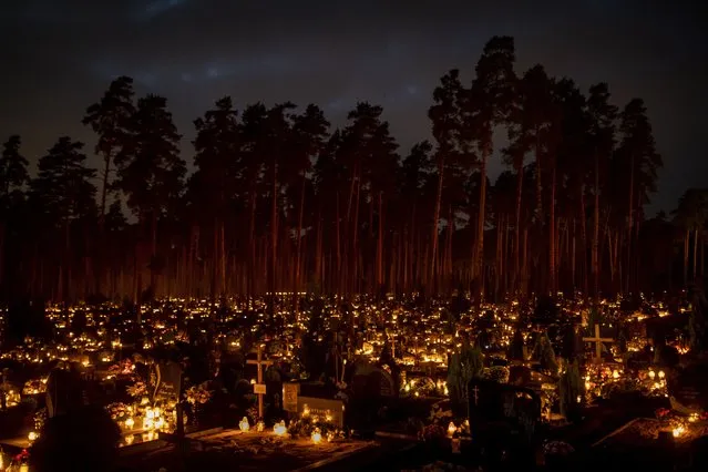 Candles are lit during All Saints Day at the cemetery in Vilnius, Lithuania, Tuesday, November 1, 2022. Candles illuminated tombstones in graveyards across Europe as people communed with the souls of the dead on Tuesday, observing one of the most sacred days in the Catholic calendar. (Photo by Mindaugas Kulbis/AP Photo)