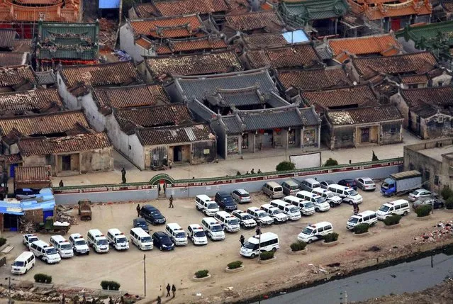 Police cars are seen during a raid where three tonnes of crystal meth were seized at Boshe village, Lufeng, Guangdong province, December 29, 2013. (Photo by Reuters/Stringer)
