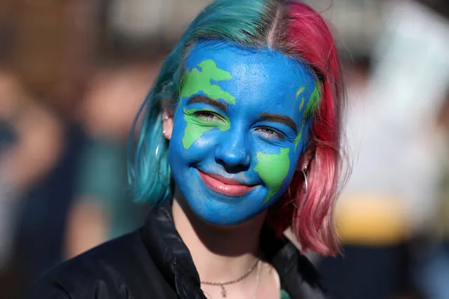 A girl looks on as people take part in a “youth strike for climate change” demonstration in London, Britain February 15, 2019. (Photo by Simon Dawson/Reuters)