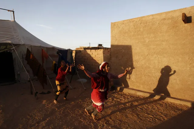 Indigenous Sahrawi girls play near their tent in a refugee camp of Al Smara in Tindouf, southern Algeria March 2, 2016. (Photo by Zohra Bensemra/Reuters)