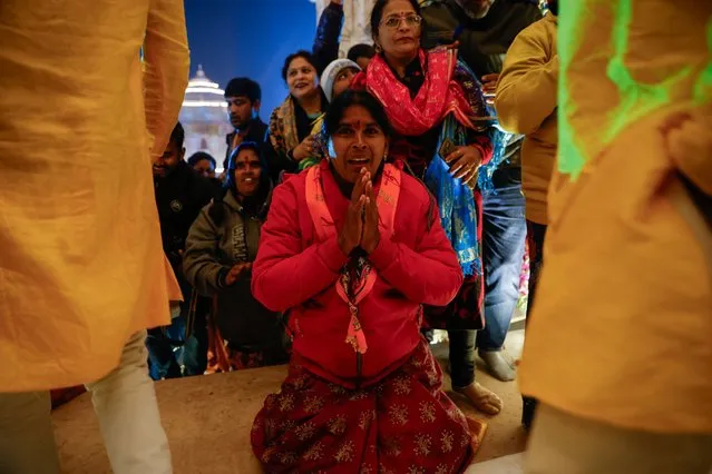 A Hindu devotee prays at the entrance to the Lord Ram temple after its inauguration, in Ayodhya, India on January 22, 2024. (Photo by Adnan Abidi/Reuters)