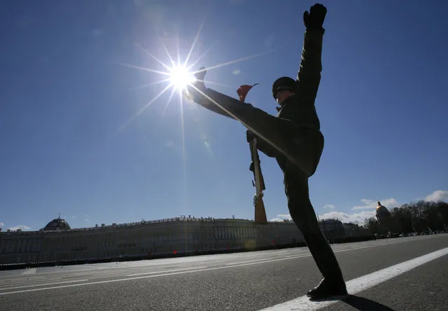 A Russian honour guard soldier marches during a rehearsal for the Victory Day military parade which will take place at Dvortsovaya (Palace) Square on May 9 to celebrate 70 years after the victory in WWII, in St. Petersburg, Russia, Thursday, April 30, 2015. (Photo by Dmitry Lovetsky/AP Photo)
