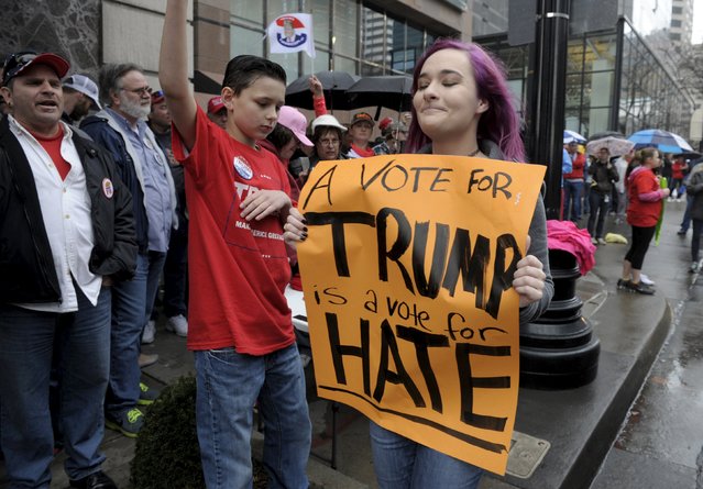 Anti-Trump protester Liz Blumenthal marches past a long line of Trump supporters before U.S. Republican presidential candidate Donald Trump speaks at a campaign rally at the downtown Midland Theater in Kansas City, Missouri, March 12, 2016. (Photo by Dave Kaup/Reuters)