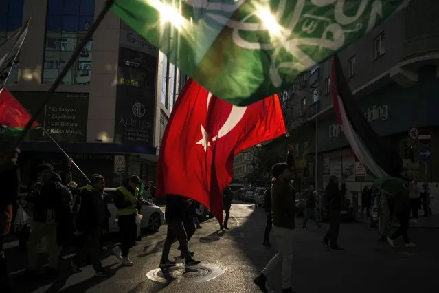 People wave Turkish and Hamas flags during a protest in support of Palestinians and calling for an immediate ceasefire in Gaza, in Istanbul, Turkey, Sunday, January 14, 2024. (Photo by Emrah Gurel/AP Photo)