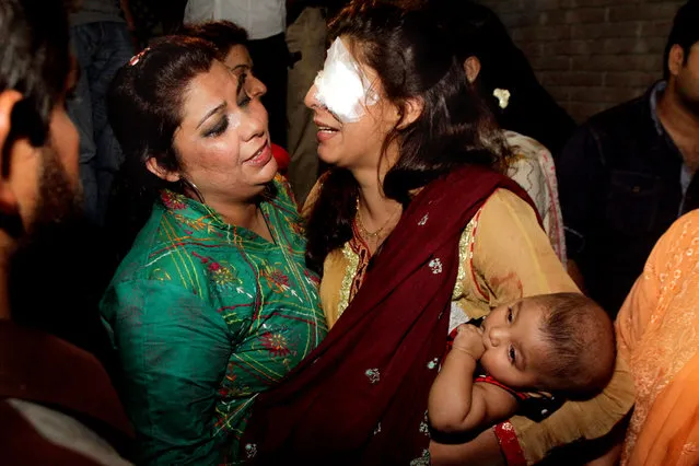 A woman injured in the bomb blast is comforted by a family member at a local hospital in Lahore, Pakistan, Sunday, March, 27, 2016. (Photo by K.M. Chuadary/AP Photo)