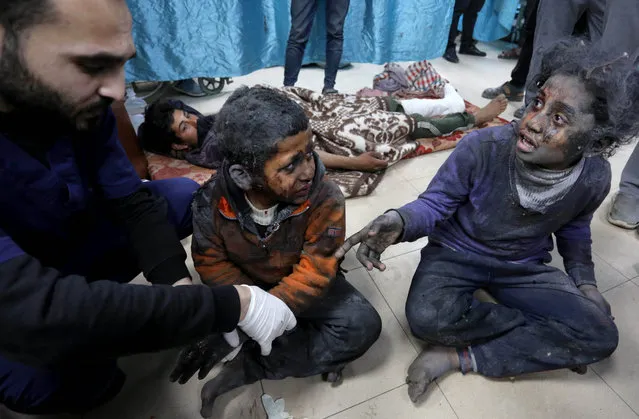 Palestinian children, injured in an Israeli attack and covered in blood, are seen in shock at Al-Aqsa Martyrs Hospital in Deir Al Balah, Gaza on March 9, 2024. (Photo by Ashraf Amra/Anadolu via Getty Images)