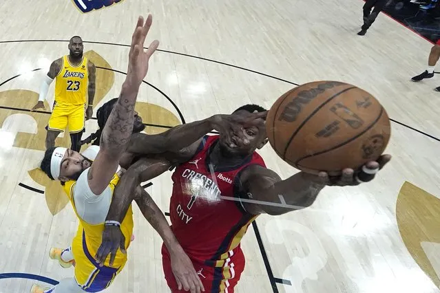 New Orleans Pelicans forward Zion Williamson (1) goes to the basket against Los Angeles Lakers forward Anthony Davis and forward Taurean Prince in the first half of an NBA basketball play-in tournament game Tuesday, April 16, 2024, in New Orleans. (Photo by Gerald Herbert/AP Photo)