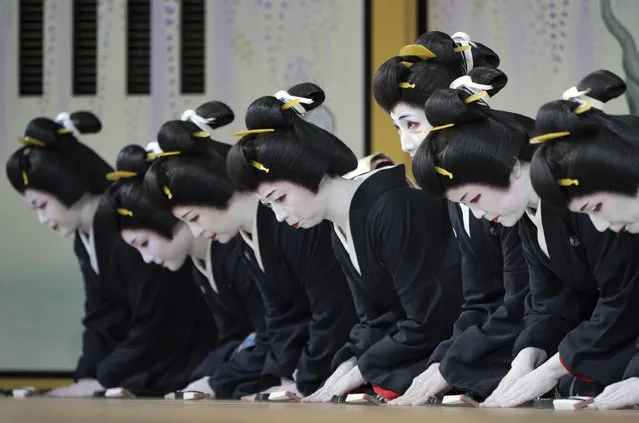 Japanese traditional female entertainers, or geisha, from Shimbashi area greet toward spectator seats during a run-through before their actual show of “Azumaodori” at Shimbashi Enbujo Theater Wednesday, May 22, 2019, in Tokyo. (Photo by Eugene Hoshiko/AP Photo)