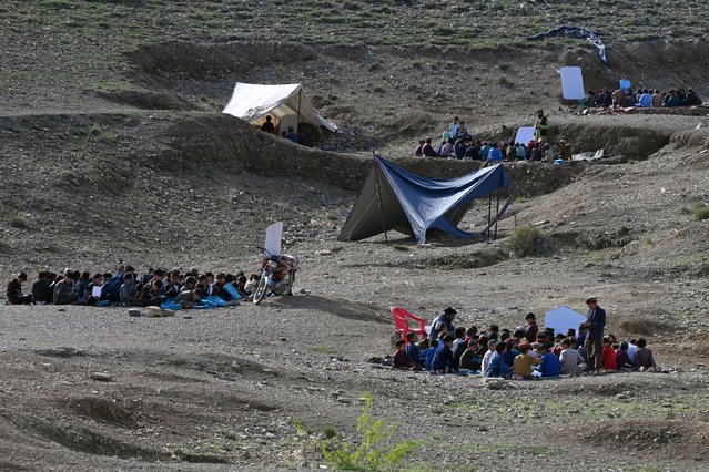 Afghan children attend an open-air school in Yaqubi in Sabari district of Khost province on April 22, 2024. (Photo by Wakil Kohsar/AFP Photo)