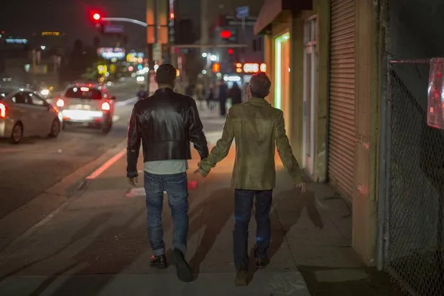 Men walk hand-in-hand down Sunset Boulevard during a rally to mark the 50th anniversary of the protest at The Black Cat Tavern, credited as the site of the first LGBTQ civil rights protest in the nation, on February 11, 2017 in Los Angeles, California. Community anger erupted in protest several weeks after police beat up patrons at the bar during New Year celebrations, arresting two of them for kissing, a s*x crime at the time. Similar social conflicts would later fuel the Stonewall riots in New York during the summer of 1969. (Photo by David McNew/Getty Images)