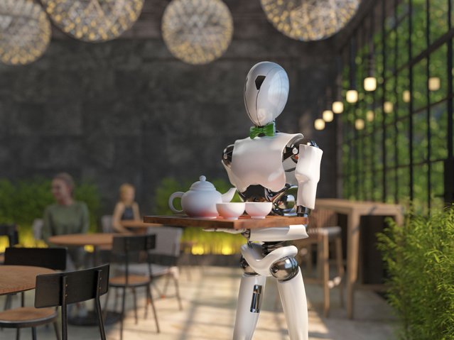 A humanoid robot waiter carries a tray of food and drinks in a restaurant. Artificial intelligence replaces maintenance staff. The concept of the future. (Photo by Julia Garan/Getty Images/iStockphoto)