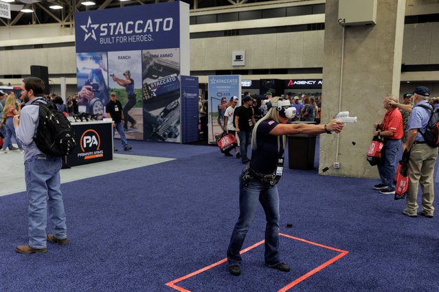 Ashley Smith of Staccato runs through a VR shooting training program during the annual National Rifle Association (NRA) meeting in Dallas, Texas, U.S., May 18, 2024. (Photo by Shelby Tauber/Reuters)