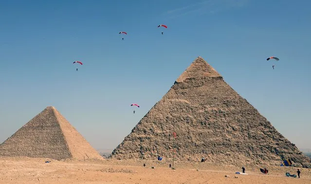 Skydivers fly over the Great Pyramids during the Egypt Air Sports Festival in Giza, Egypt, 01 November 2021. Dozens of international athletes participated in the fourth edition of the Air Sports Festival. (Photo by Khaled Elfiqi/EPA/EFE)