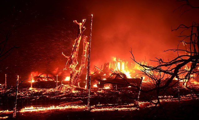 A home near Tracy, California, burns during the Corral Fire on Saturday, June 1, 2024. The grass fire began in Tracy on Saturday, forcing some evacuations. (Photo by Kent Porter/The Press Democrat/AP Photo)