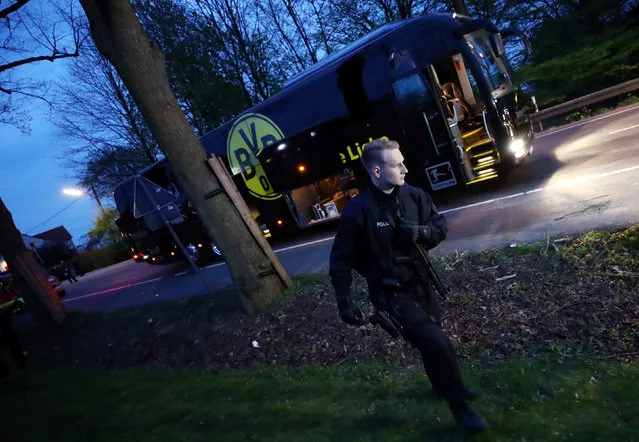 The bus carrying the Borussia Dortmund squad in a street in Dortmund, Germany, 11 April 2017 with a visibly damaged window. Three explosive devices detonated near the bus shortly after its departure from the hotel in which the team was staying according to a statement by police in the city. The bus was damaged in two places. One person was injured and treated in a hospital. (Photo by Kai Pfaffenbach/Reuters/Livepic)