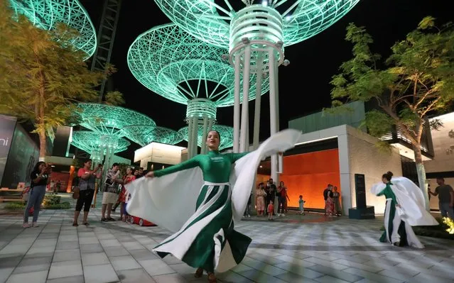 Women in Saudi National flag colours and logo outfit, perform during Saudi National Day celebrations at the Bluewaters Island in Dubai, United Arab Emirates, Friday, September 20, 2019. UAE celebrates the Saudi Arabia's 89th National Day on Sept. 23. (Photo by Kamran Jebreili/AP Photo)