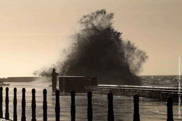  Hardy fishermen brave the wind whipped waves to fish off Blackpool promenade