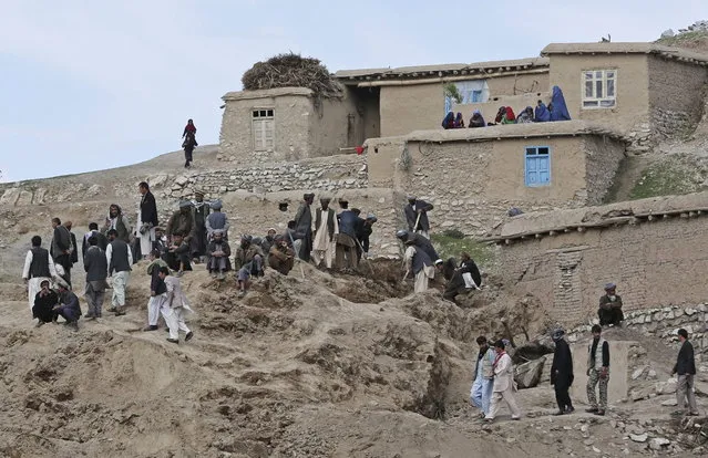 Survivors search for their relatives' bodies at the site of Friday's landslide that buried Abi Barik village in Badakhshan province, northeastern Afghanistan, Monday, May 5, 2014. The landslide Friday killed hundreds of people – still no one has an exact number – and destroyed 300 homes and displaced hundreds more families. (Photo by Massoud Hossaini/AP Photo)