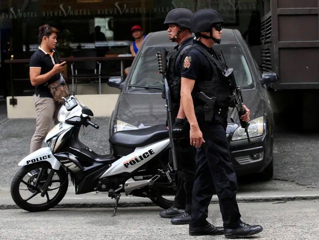 Members of the Philippine National Police (PNP) Special Weapons And Tactics (SWAT) patrol along a main street of metro Manila in the Philippines May 12, 2016. (Photo by Romeo Ranoco/Reuters)