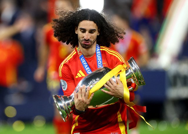 Spain's Marc Cucurella celebrates with the trophy after winning the UEFA Euro 2024 Final match at the Olympiastadion in Berlin on July 14, 2024. (Photo by Lisi Niesner/Reuters)