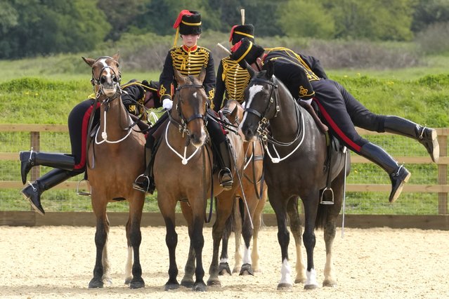 Soldiers in the Kings Troop Royal Horse Artillery (KTRHA) mount their horses as they take part in an Advanced Mounted Gunner Pass Out final assessment in London, Monday, April 24, 2023. Passing the course will enable the soldiers to ride on ceremonial parades including the gun salute to celebrate the moment King Charles III is crowned. (Photo by Kirsty Wigglesworth/AP Photo)