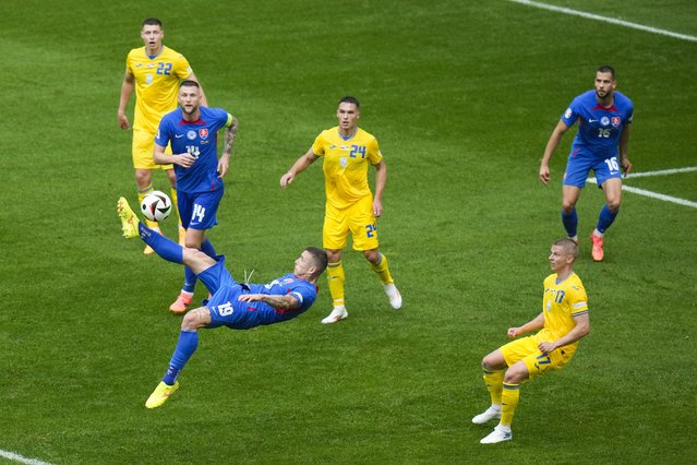 Slovakia's Juraj Kucka, bottom left, shoots during a Group E match between Slovakia and Ukraine at the Euro 2024 soccer tournament in Duesseldorf, Germany, Friday, June 21, 2024. (Photo by Alessandra Tarantino/AP Photo)