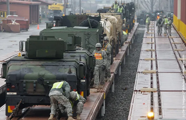 United States Forces Korea (USFK) including soldiers from the 1st Battery, 145th Field Artillery deployed from the United States, load equipment from APS-4 (Army Prepositioned Stocks) stocks onto the railhead during the Key Resolve/Foal Eagle exercise at Camp Carroll on March 6, 2012 in Waegwan, South Korea. The annual combined Field Training Exercise, part of Key Resolve/Foal Eagle 2012, is conducted between the Republic of Korea and United States Forces Korea (USFK) and is one of the largest annual military training exercises in the world
