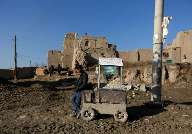 An Afghan man selling popcorn waits for customers on a muddy road in Kabul, Afghanistan February 20, 2017. (Photo by Mohammad Ismail/Reuters)