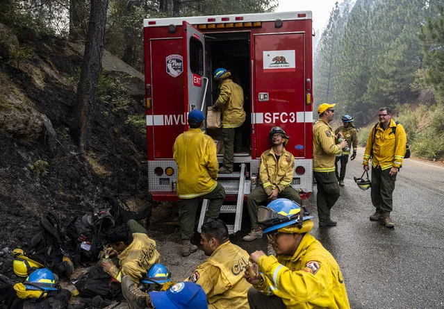 California Conservation Corps firefighters eat and hydrate after a shift cutting fireline at the Caldor Fire Thursday, August 19, 2021, in Grizzly Flats, Calif. (Stuart W. Palley/The Washington Post)