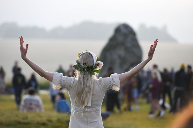 Visitors welcome the sun at Stonehenge on June 21, 2023 in Wiltshire, England. In the Northern Hemisphere, the longest day of the year falls on the 21st of June. This day is often referred to as the Summer Solstice or Midsummer's Day. (Photo by Finnbarr Webster/Getty Images)