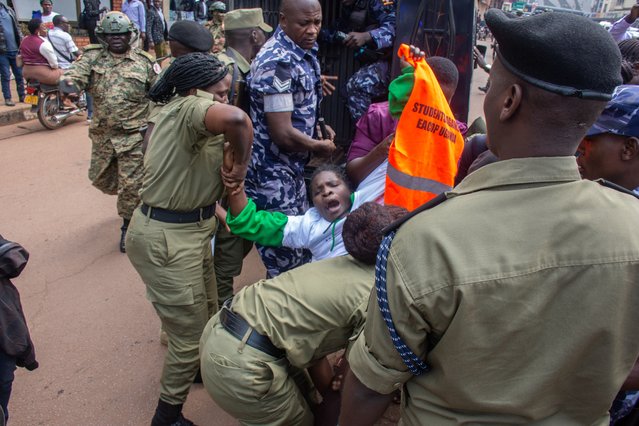 A demonstrator is detained by police during a protest against the East African Crude Oil Pipeline Project (EACOP) in Kampala, Uganda, 26 August 2024. The EACOP, backed by the French oil company Total and the state-owned China National Offshore Oil Corporation, with the Ugandan and Tanzanian government's holding minority stakes, is a crude oil pipeline in planning since 2013 which, when in operation, will transport oil produced from Uganda’s Lake Albert oilfields to the port of Tanga in Tanzania, where the oil will then be sold onwards to world markets. Environmentalists claim the route of the pipeline endangers several national parks and will displace tens of thousands of people from their homes. (Photo by Isaac Kasamani/EPA/EFE)