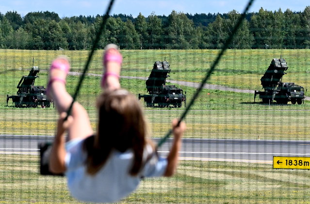 A child on playground near by patriot long-range air defence systems of the German Bundeswehr armed forces at Vilnius Airport ahead of the upcoming NATO Summit in Vilnius, Lithuania, 08 July 2023. NATO Summit will take place in Vilnius on 11 and 12 July 2023. (Photo by Filip Singer/EPA)