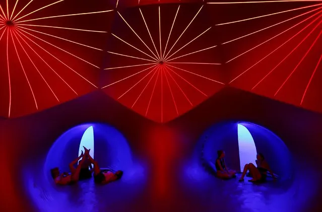 Revellers relax inside a 3-D Luminarium inflatable installation by British designer Alan Parkinson during Sziget music festival on an island in the Danube River in  Budapest, Hungary August 12, 2015. (Photo by Laszlo Balogh/Reuters)
