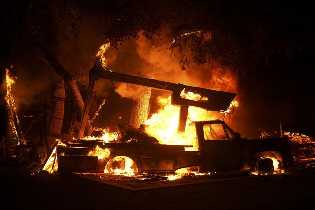 A vehicle burns from the Airport Fire Tuesday, September 10, 2024, in El Cariso, an unincorporated community in Riverside County, Calif. (Photo by Eric Thayer/AP Photo)