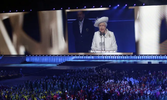 Britain's Queen Elizabeth II is seen on a large video screen as she speaks during the opening ceremony for the Commonwealth Games 2014 in Glasgow, Scotland, Wednesday, July 23, 2014. (Photo by Kirsty Wigglesworth/AP Photo)