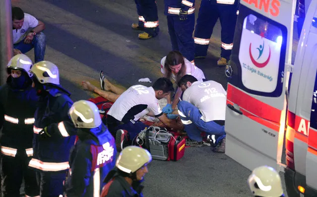 Turkish rescue services members help a wounded person outside Istanbul's Ataturk airport, Tuesday, June 28, 2016. (Photo by Ismail Coskun/IHA via AP Photo)