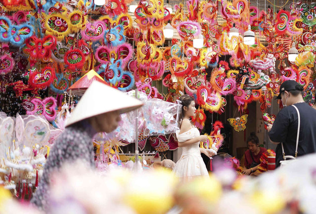 People visit the traditional market for the Mid-Autumn Festival, or Moon Festival, in the old quarter of Hanoi, Vietnam Tuesday, September 17, 2024. (Photo by Hau Dinh/AP Photo)