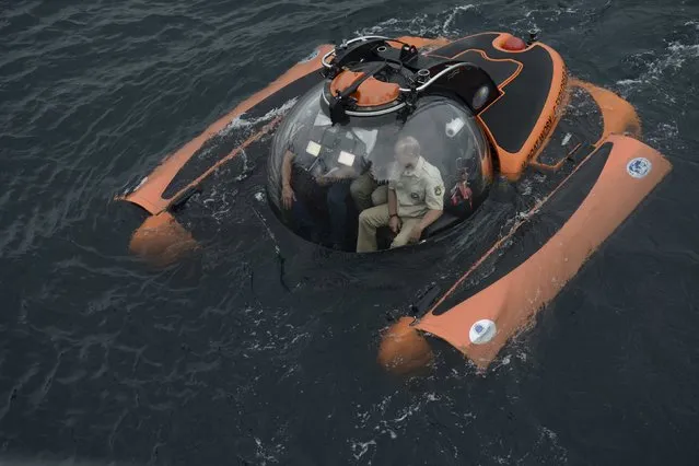 Russian President Vladimir Putin (R) is seen inside a research bathyscaphe while submerging into the waters of the Black Sea as he takes part in an expedition near Sevastopol, Crimea, August 18, 2015. (Photo by Alexei Nikolsky/Reuters/RIA Novosti/Kremlin)