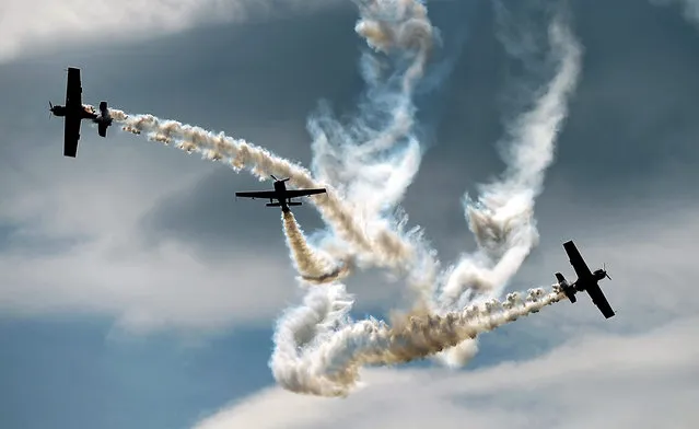 Planes of various types of the Polish aerobatic team “Zelazny” perform during an air show within the so-called “Szczecin Air Picnic” of the local Aeroclub in Szczecin, Poland, July 2, 2016. (Photo by Marcin Bielecki/EPA)