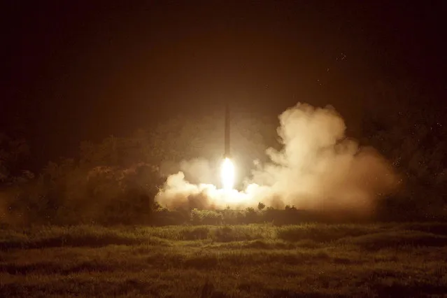 A tactical rocket firing drill carried out by units of the Korean People's Army (KPA) Strategic Force is seen during a visit by North Korean leader Kim Jong Un in the western sector of the front in this undated photo released by North Korea's Korean Central News Agency (KCNA) in Pyongyang on July 10, 2014. (Photo by Reuters/KCNA)