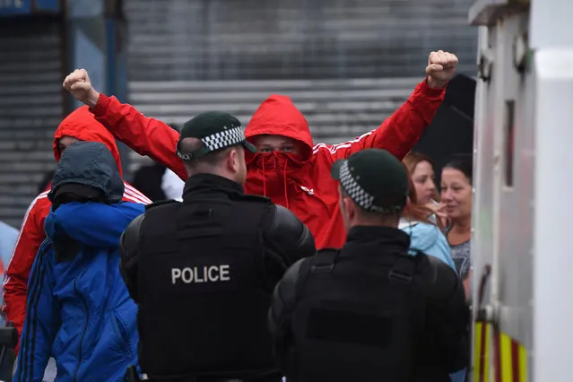 Nationalists in the Ardoyne area are seen clashing with police after the annual Twelfth of July Orange Order Parade in Belfast, Northern Ireland, July 12, 2016. (Photo by Clodagh Kilcoyne/Reuters)