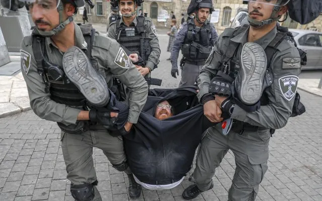 Israeli security forces arrest an Ultra Orthodox Jewish man as they close a synagogue in the Mea Shearim Ultra-Orthodox neighbourhood in Jerusalem, on March 30, 2020, amid efforts to curb the spread of the COVID-19 coronavirus pandemic. (Photo by Ahmad Gharabli/AFP Photo)