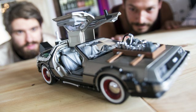 The director and actor at copy & waste Steffen Klewar  (L) and actor Daniel Brunet pose behind a car model of a DeLorean DMC-12 at the concept store “Knick-Knack to the Future” in Berlin, Germany, September 1, 2015. The Berlin-based collective of artists, called copy & waste, selling coffee, cupcakes and “Back to Future”-themed bags, shoes and T-shirts. (Photo by Hannibal Hanschke/Reuters)