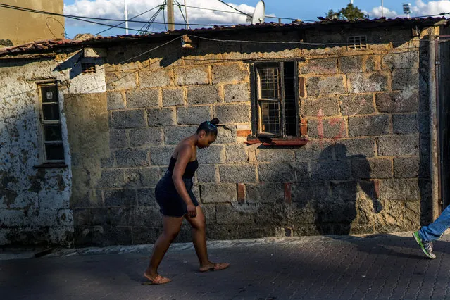 A woman walks back to her home after being summoned to do so by a South African police patrol in the densely populated Alexandra township of Johannesburg, Monday April 6, 2020. More than half of Africa’s 54 countries have imposed lockdowns, curfews, travel bans or other restrictions to try to contain the spread of COVID-19. (Photo by Jerome Delay/AP Photo)