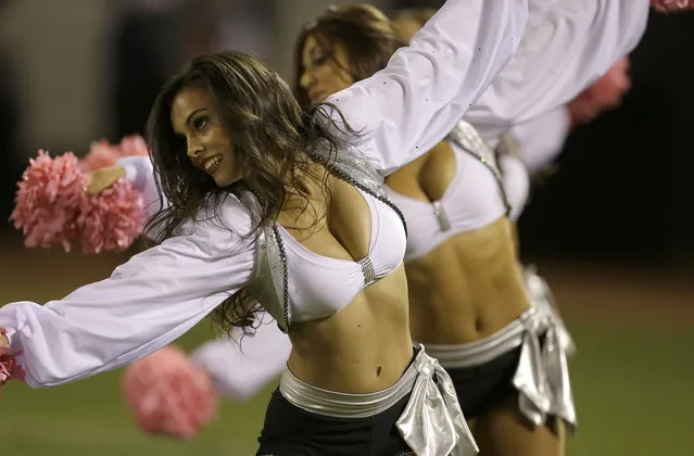 Oakland Raiders cheerleaders perform during the first half of an NFL football game against the San Diego Chargers in Oakland, Calif., Sunday, October 6, 2013. (Photo by Ben Margot/AP Photo)